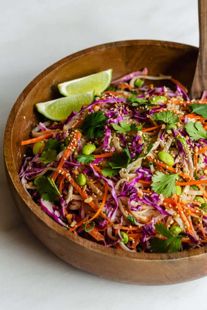 A bowl of Thai noodle salad with with cilantro and limes