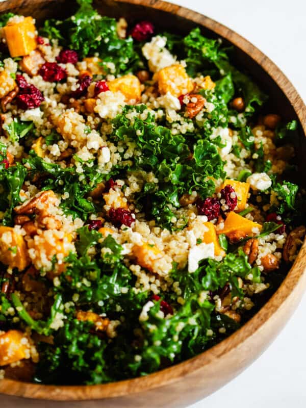 squash, kale and quinoa salad in a wooden bowl