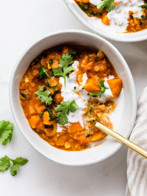 A bowl of sweet potato lentil curry topped with cilantro