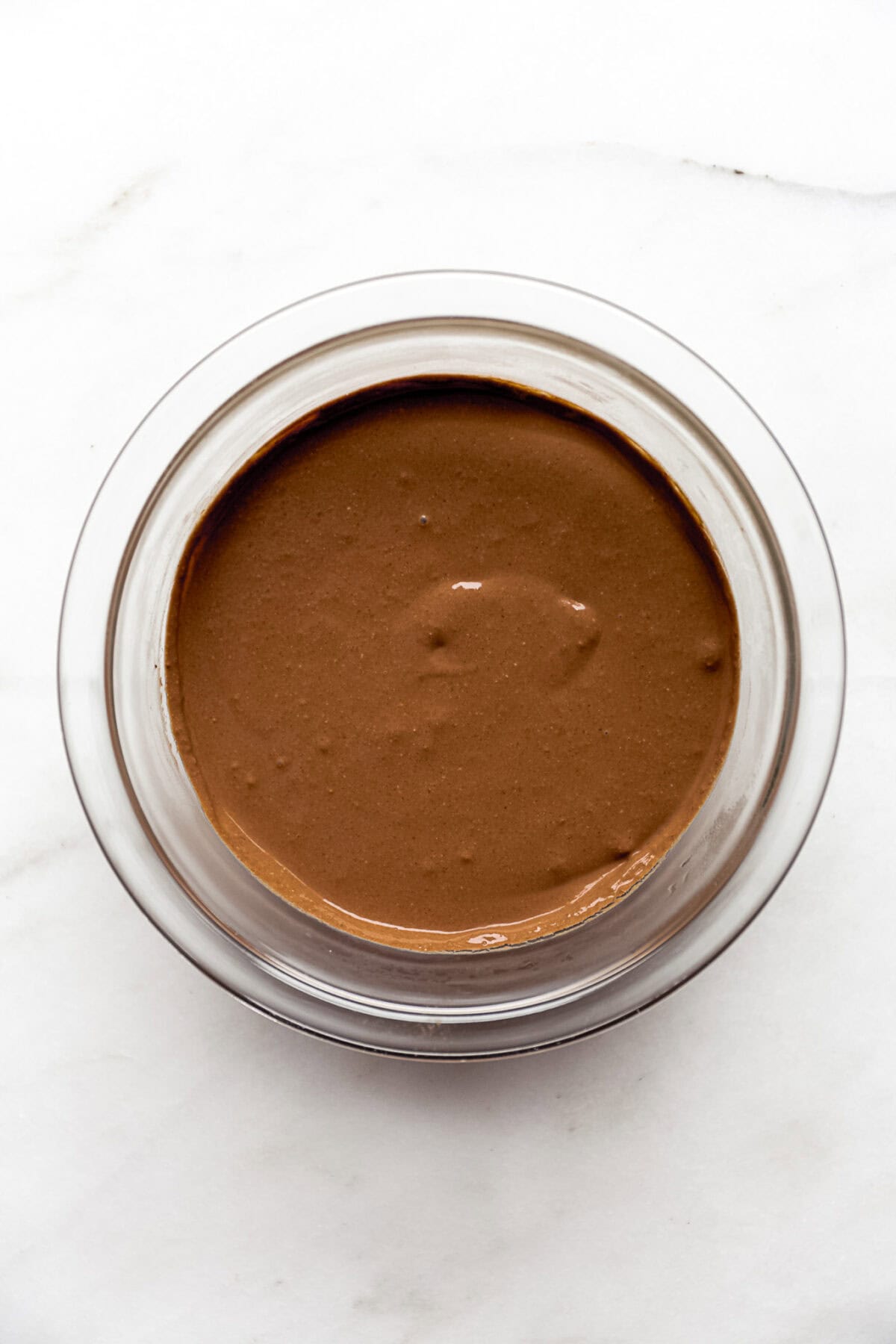 cottage cheese chocolate mousse in a clear mixing bowl.