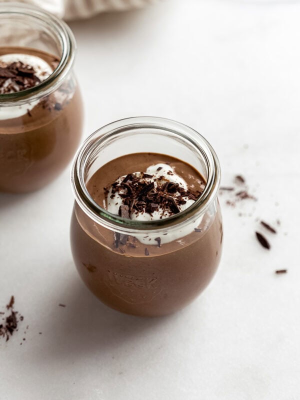 cottage cheese chocolate mousse in a small jar with yogurt and chocolate on top.