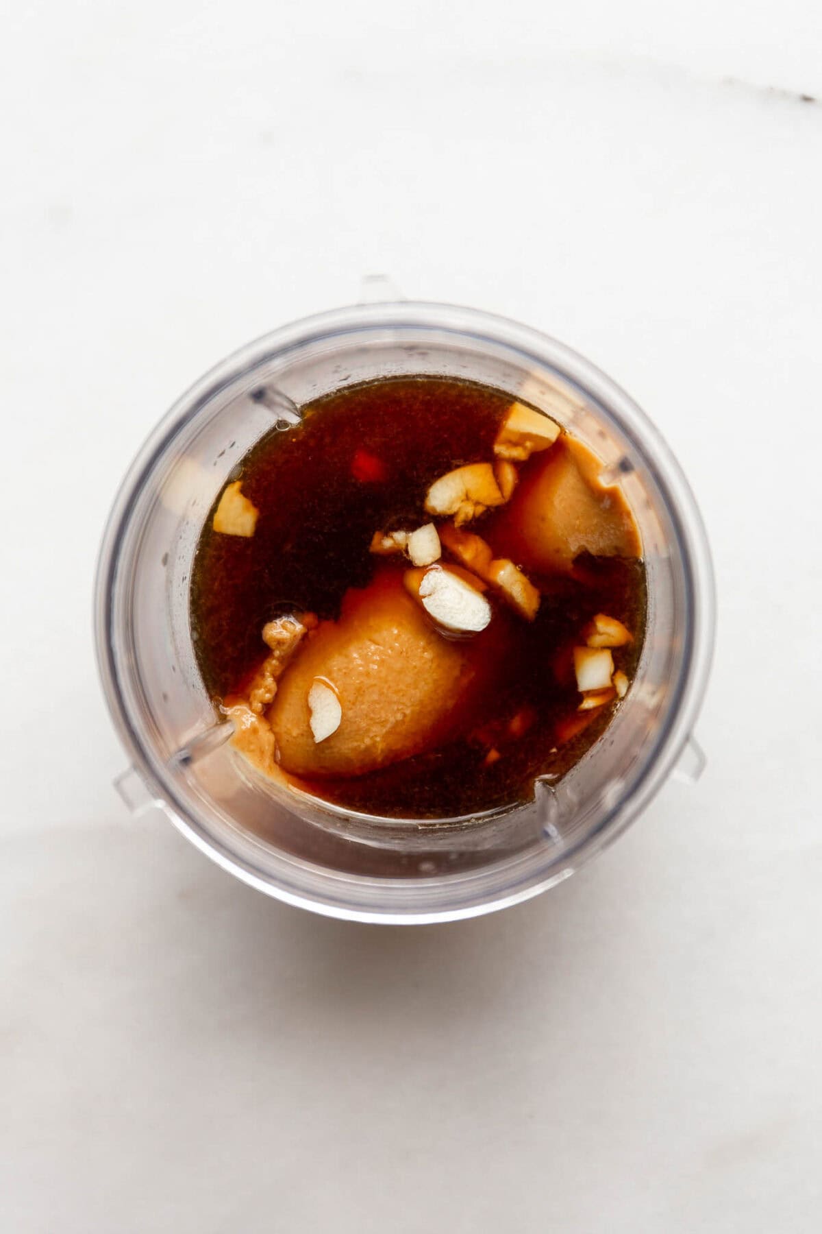 Peanut butter, tamari, garlic, lemon juice and avocado oil in a magic bullet container.