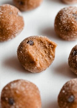 a banana protein ball with a bite taken out of it.
