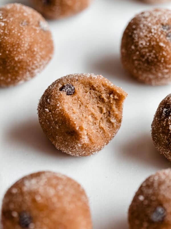 a banana protein ball with a bite taken out of it.