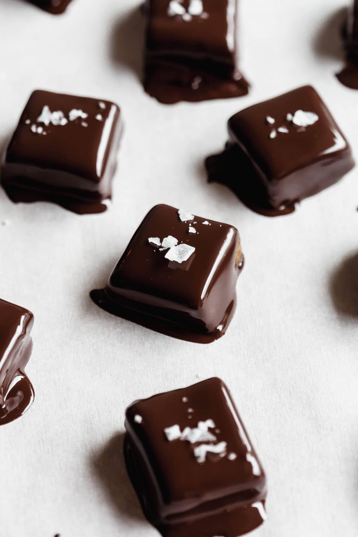 Date caramels dipped in melted dark chocolate topped with salt.