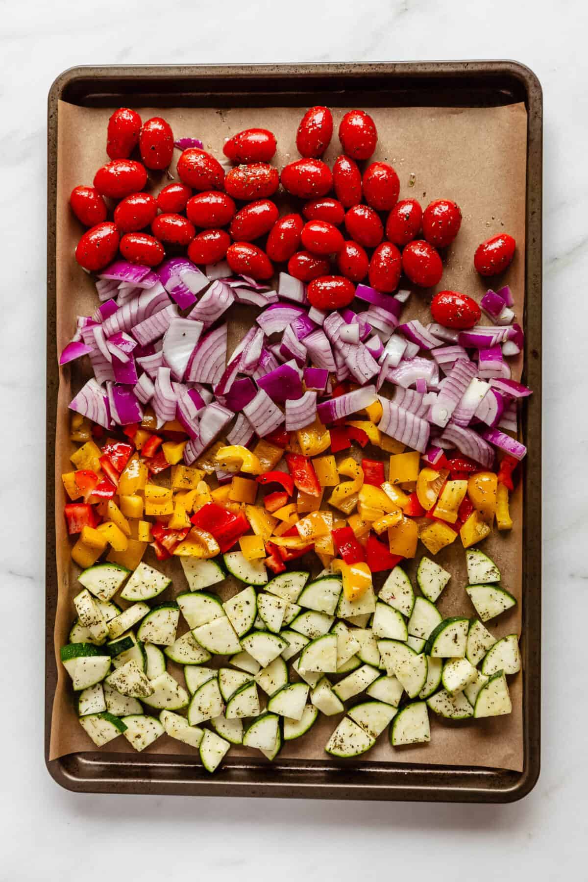 vegetables on a baking sheet with parchment paper.