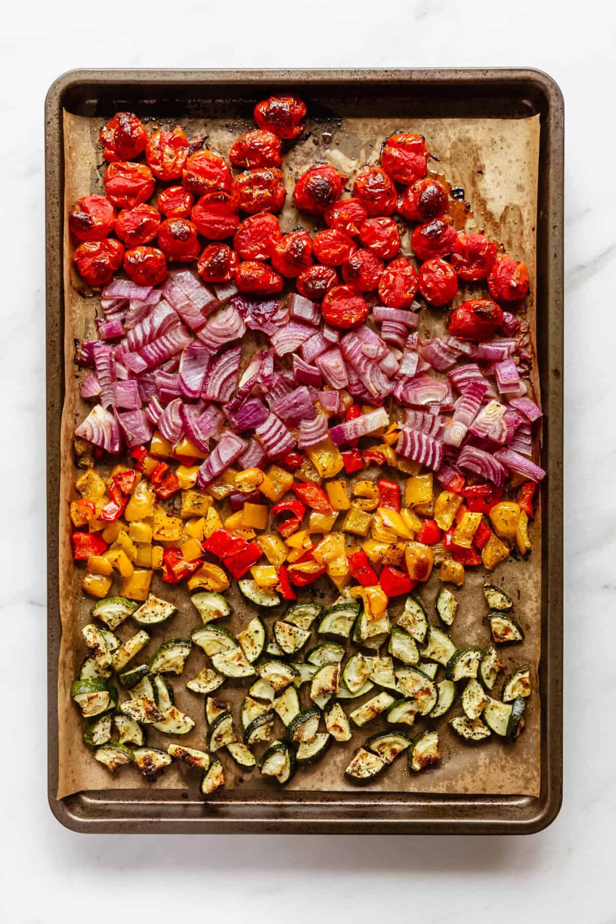 roasted vegetables on a baking sheet.