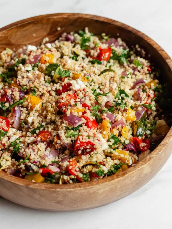 roasted vegetable quinoa salad in a wood bowl.