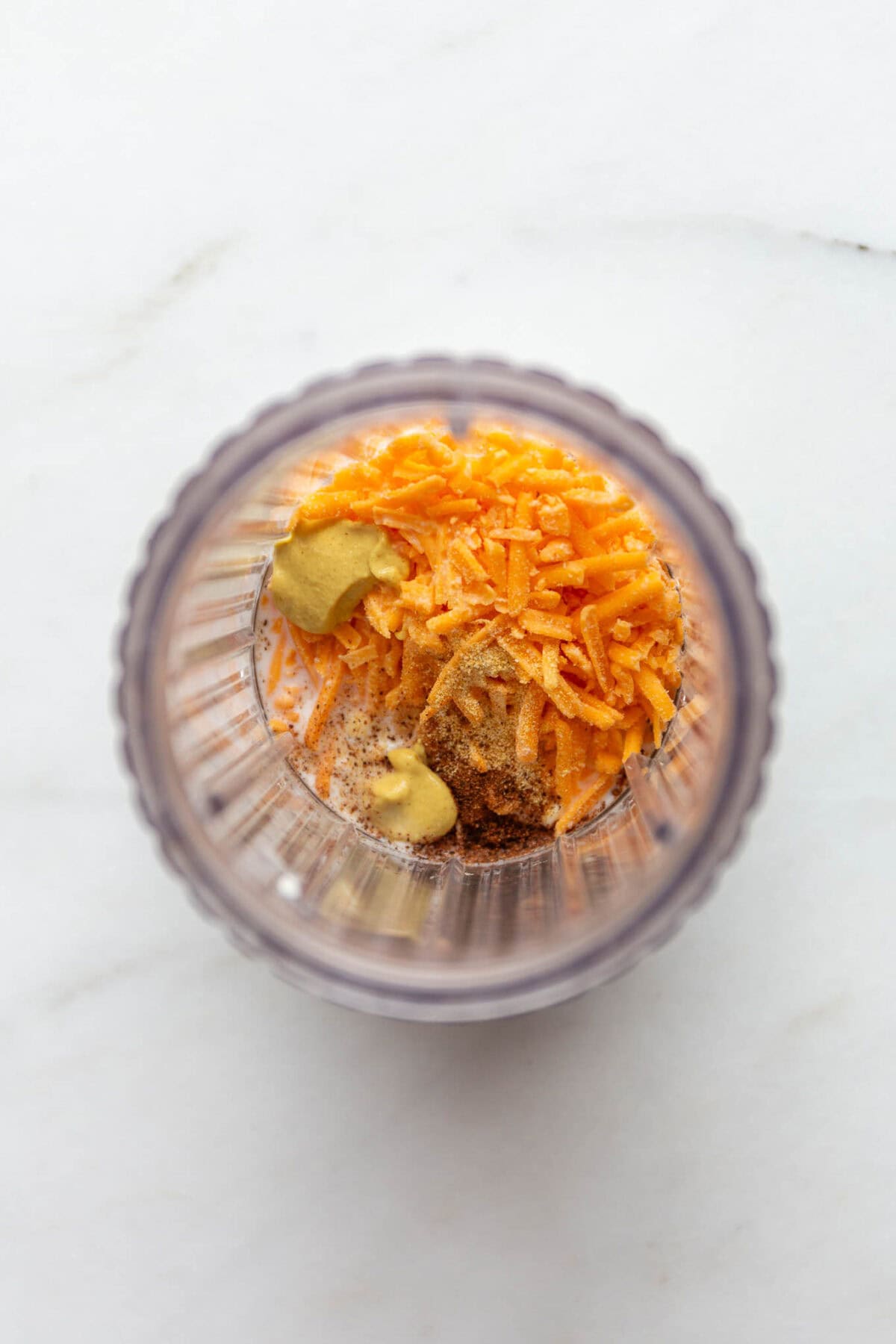 cottage cheese, cheddar cheese and dijon in a blender container.