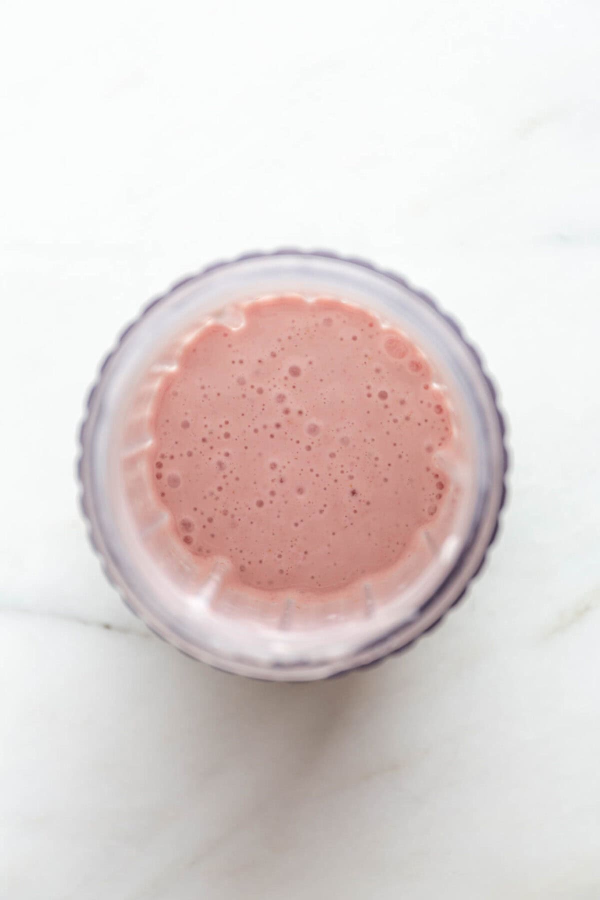 Blended cottage cheese, raspberries, maple syrup and vanilla in a blender container.