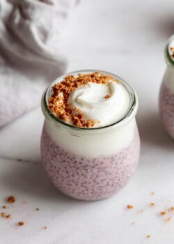 Protein chia pudding in a cup topped with graham cracker crumbs.
