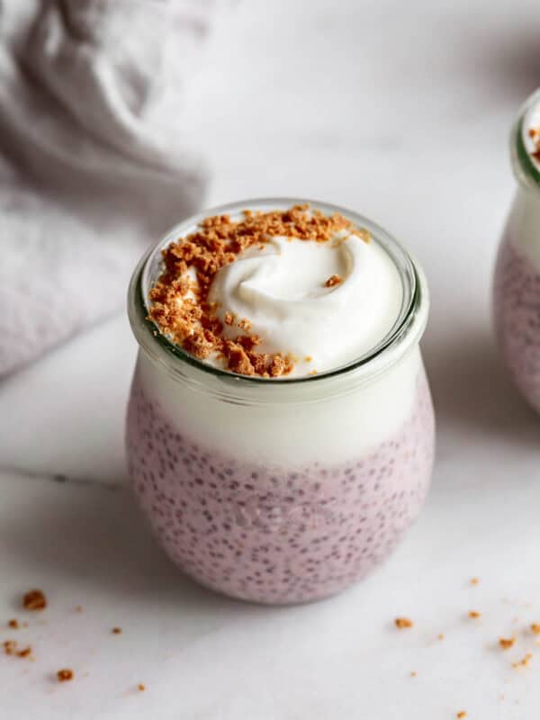 Protein chia pudding in a cup topped with graham cracker crumbs.