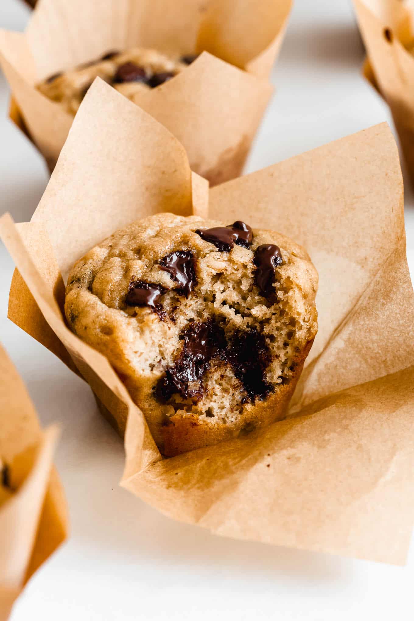 A protein banana muffin with a bite taken out of it.