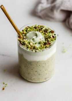 a jar of Pistachio overnight oats with a gold spoon in it.