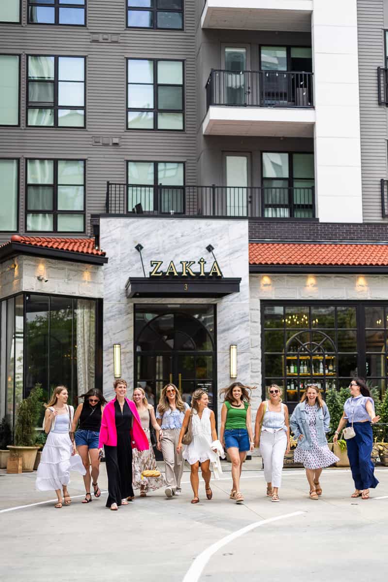 girls walking out of a restaurant.