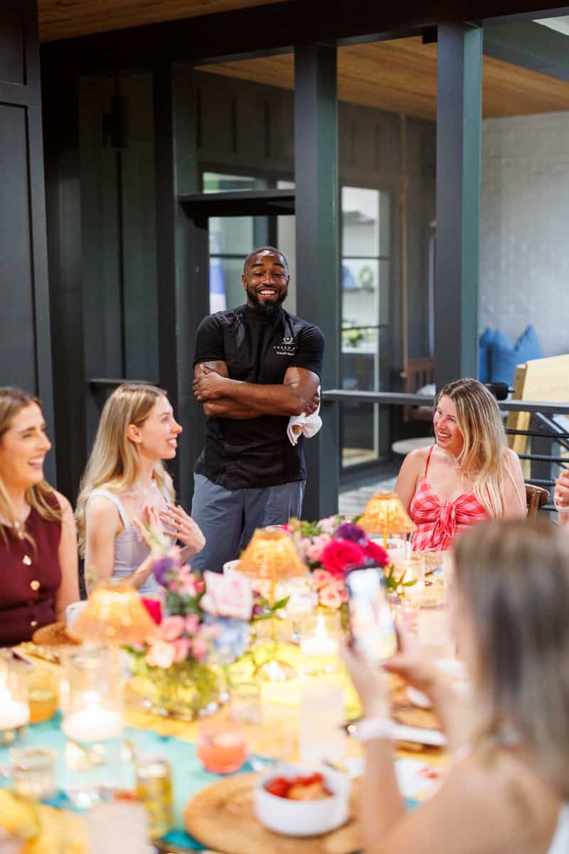 people laughing at a dinner table.