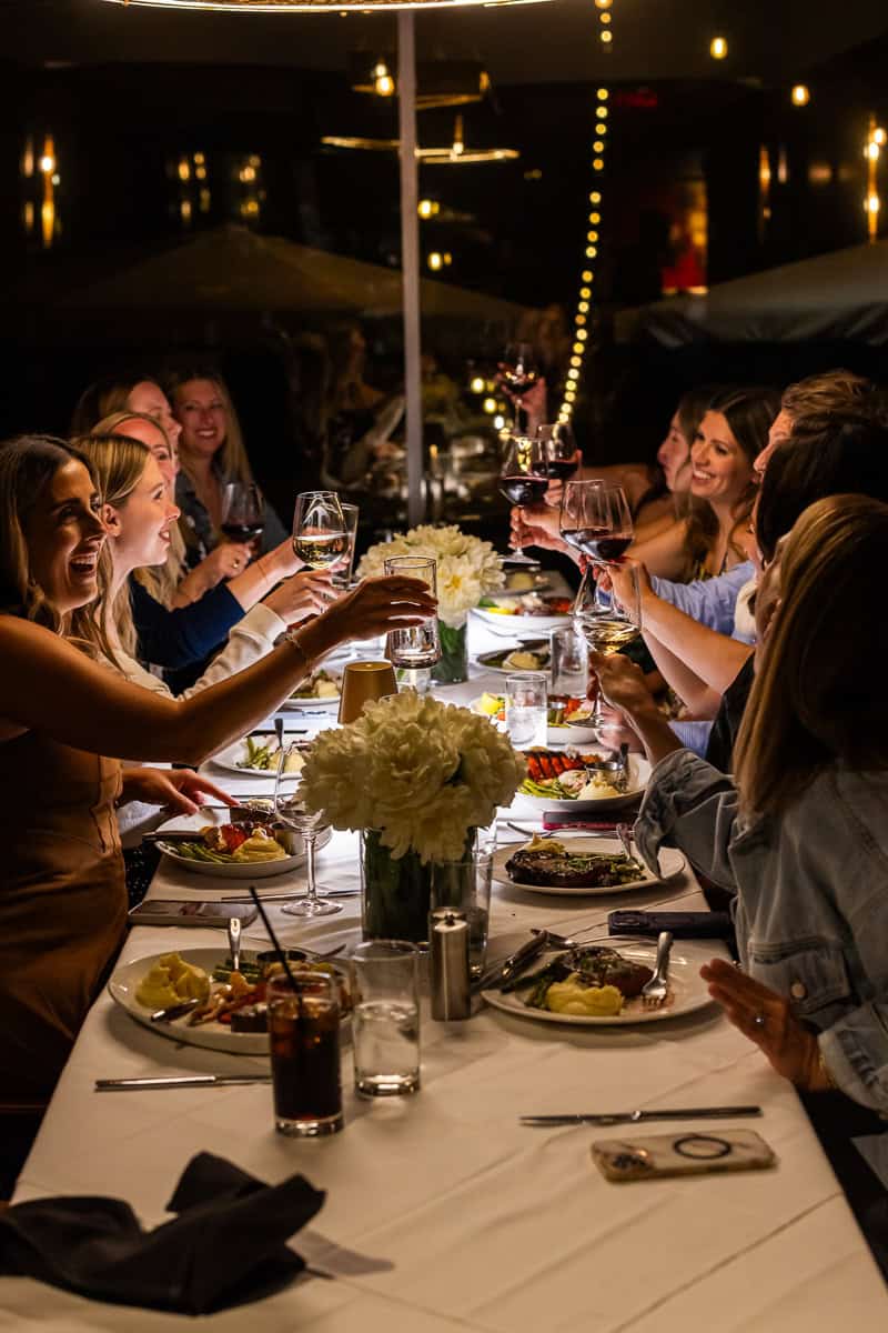 girls doing a dinner cheers.