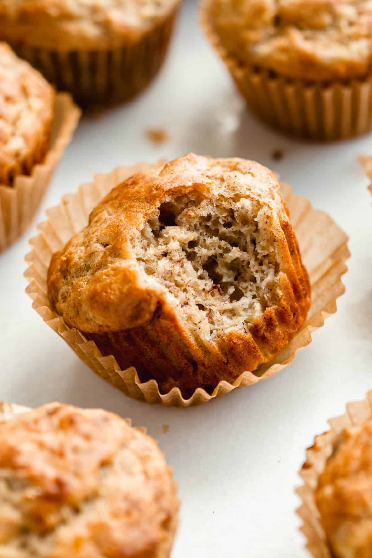 A banana muffin with a bite taken out of it.