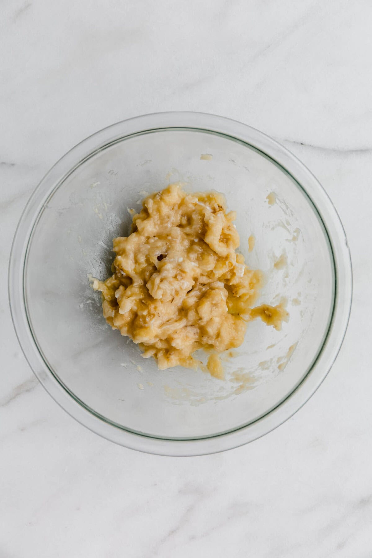 mashed banana in a mixing bowl.