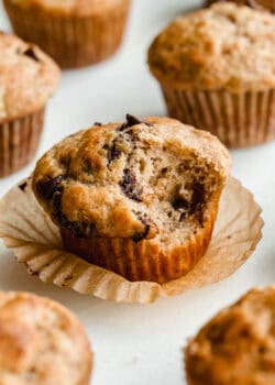 A cottage cheese banana muffins with chocolate chips with a bite taken out of it.