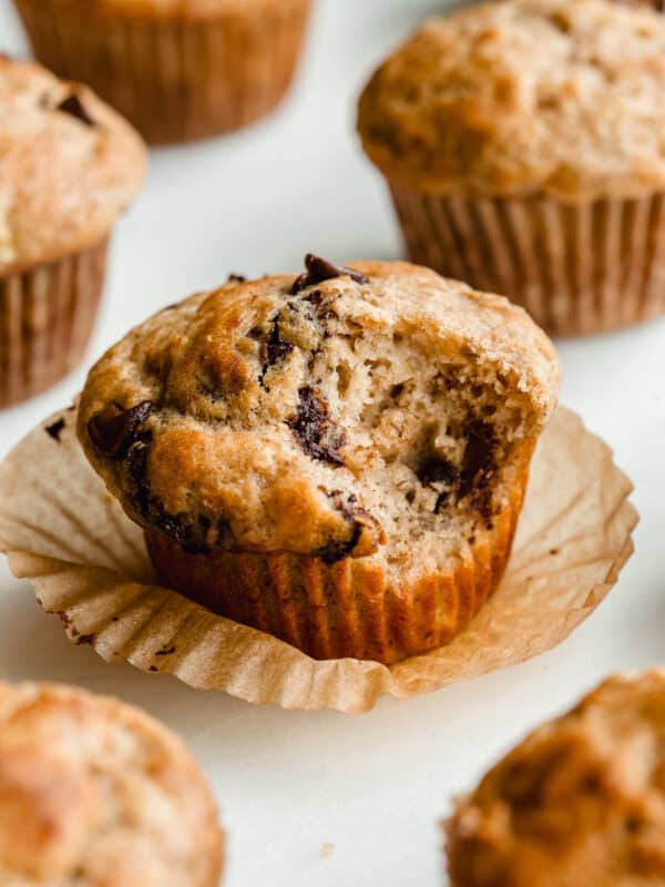 A cottage cheese banana muffins with chocolate chips with a bite taken out of it.