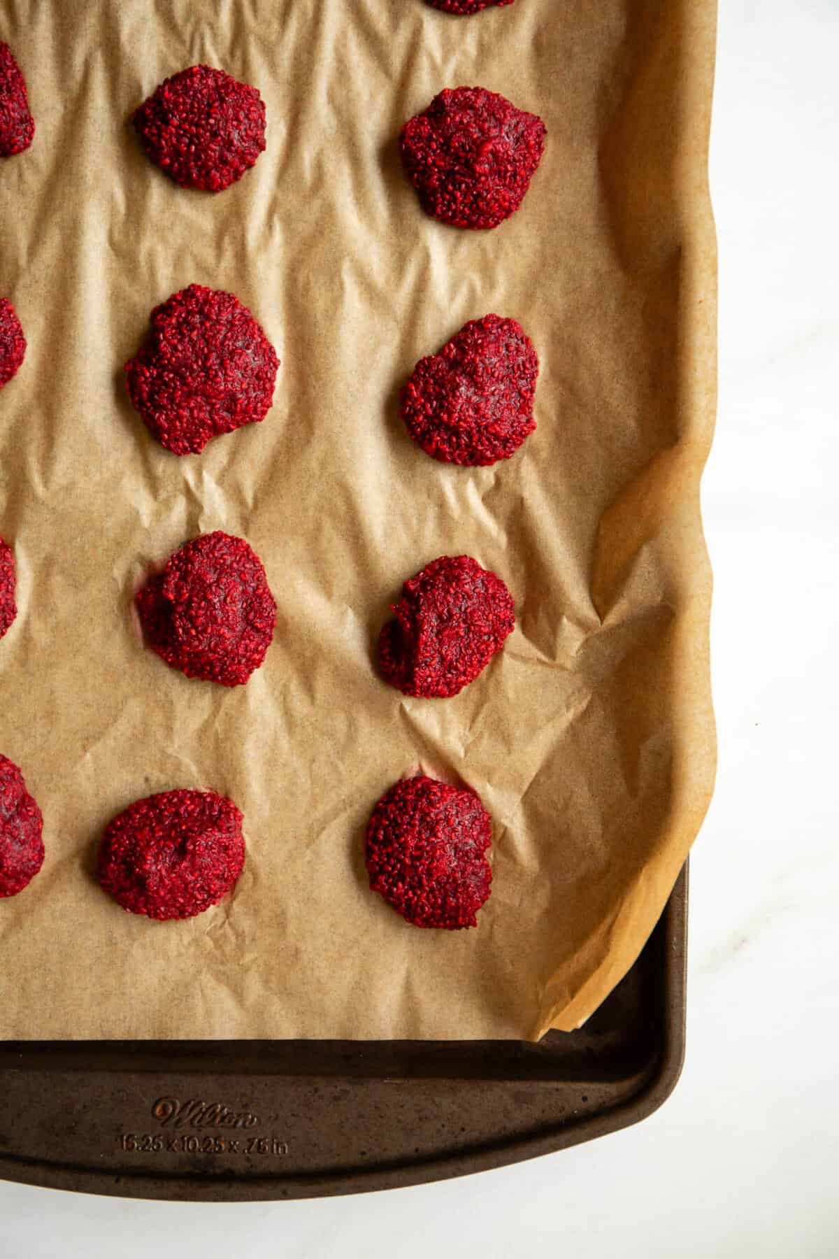frozen raspberry chia jam clusters on a baking sheet.