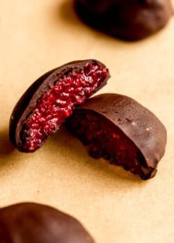 A chocolate chia jam bite cut in half with raspberry jam filling.