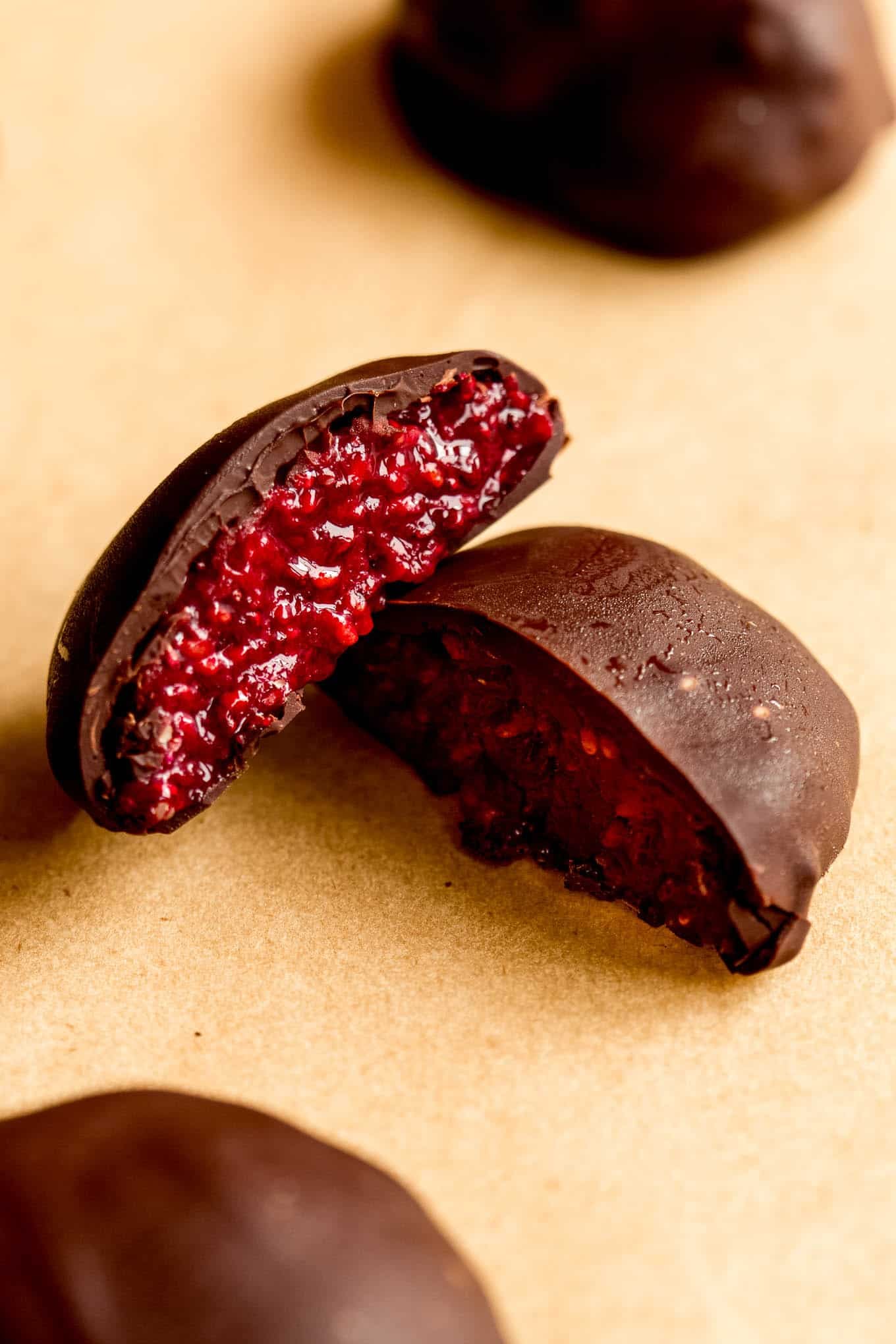A chocolate chia jam bite cut in half with raspberry jam filling.