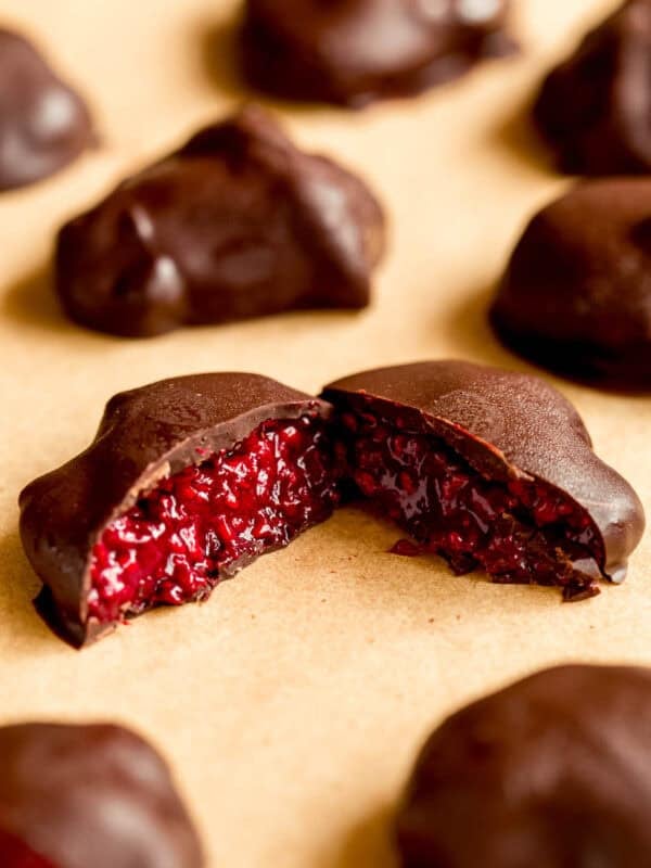 A chocolate chia jam bite cut in half with raspberry jam filling.