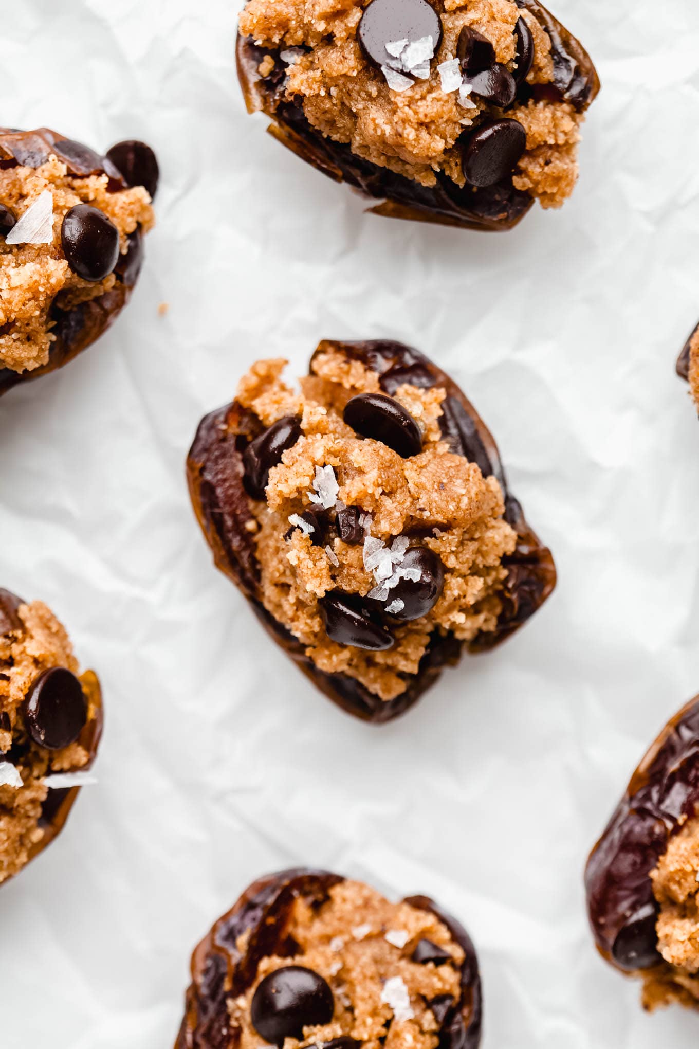 cookie dough stuffed dates in a sheet of parchment paper.