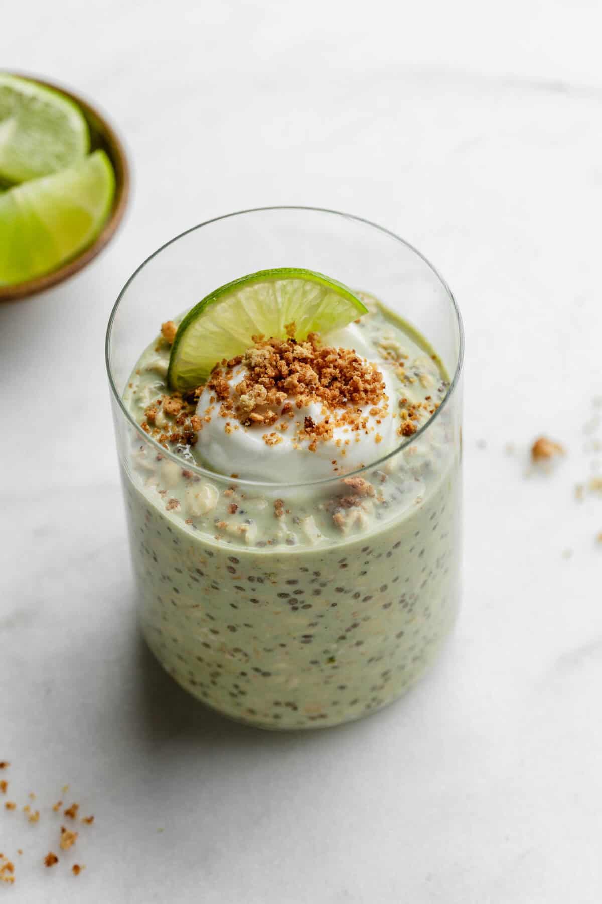 Key lime pie overnight oats topped with yogurt and graham cracker crumbs.