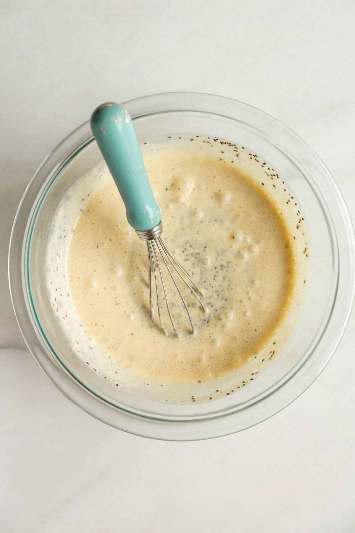 Whisking chia pudding mixture in a bowl for passionfruit chia pudding