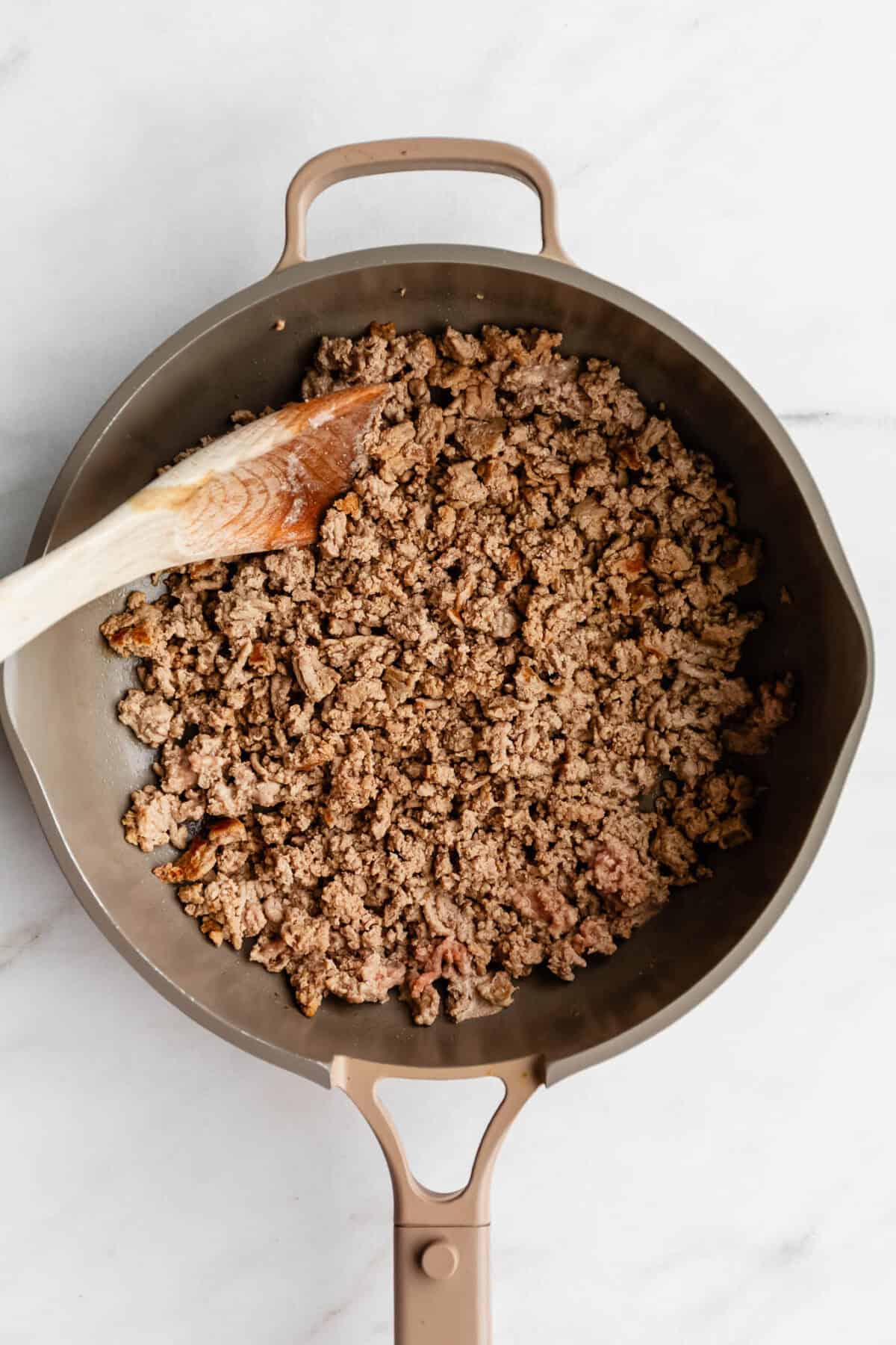 Ground turkey in a taupe pan.