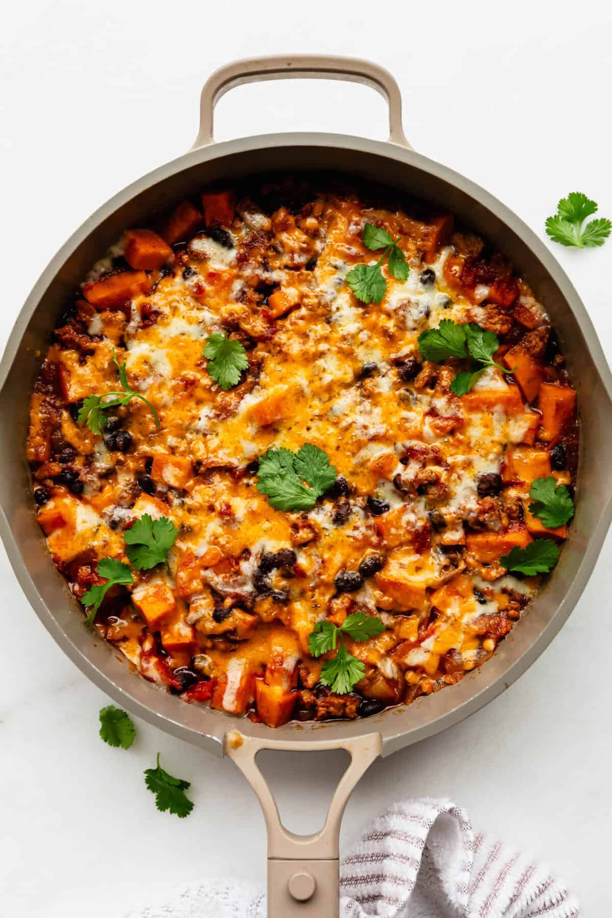 Ground turkey sweet potato skillet in a taupe pan.