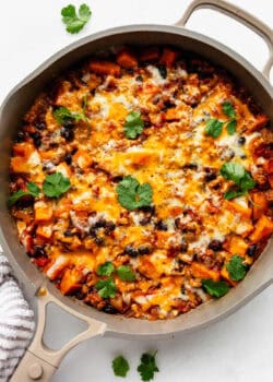 ground turkey sweet potato skillet topped with melted cheese and cilantro.