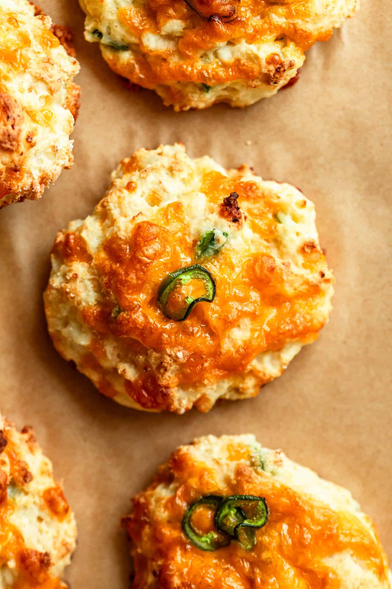 A jalapeno cheddar cottage cheese biscuit on brown parchment paper.