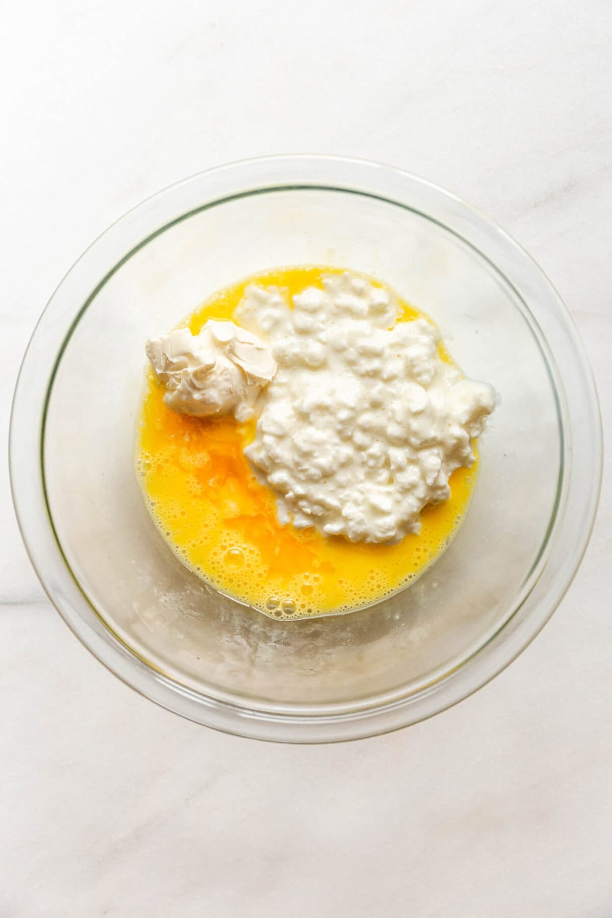 A bowl with cottage cheese and egg.