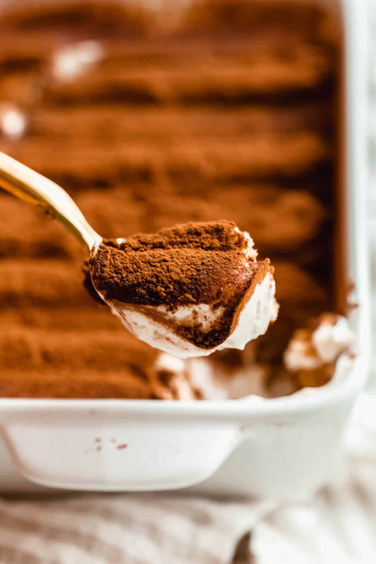 A close-up view of Greek yogurt tiramisu layers showing espresso-soaked ladyfingers.