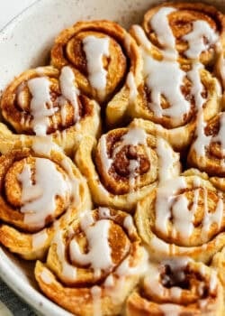 Close-up of glazed cottage cheese cinnamon rolls with icing drizzle.