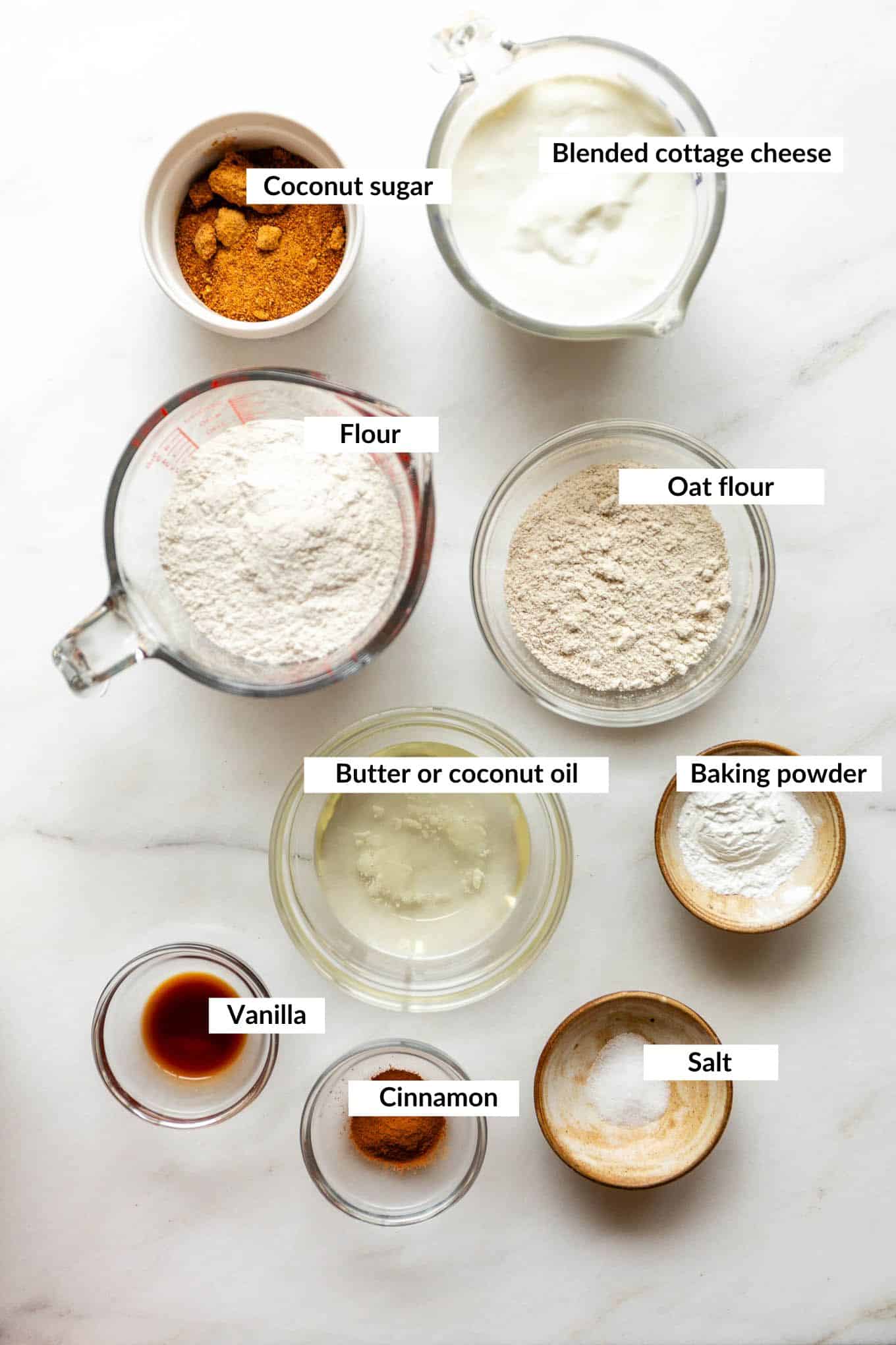 Ingredients for cottage cheese cinnamon rolls including cottage cheese, flour, butter, and cinnamon.