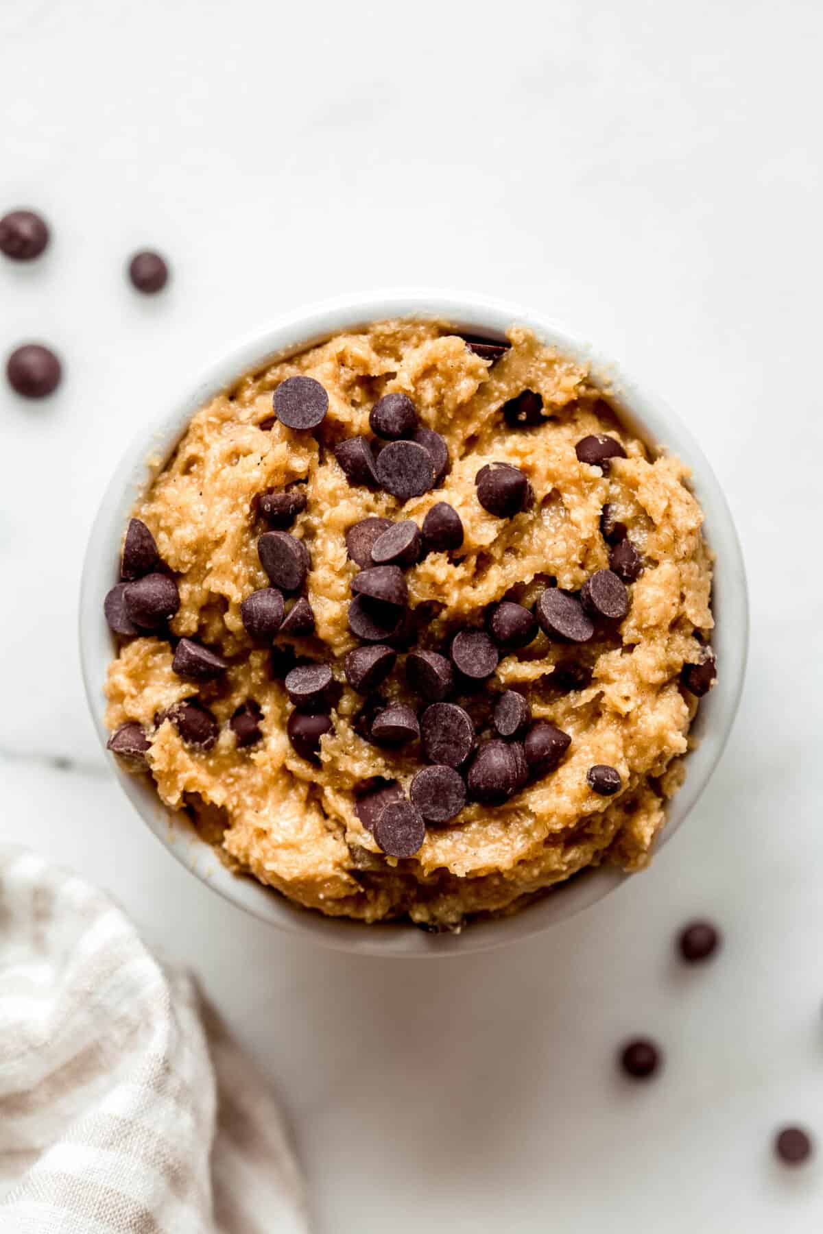 Cottage cheese cookie dough in a ramekin topped with chocolate chips.