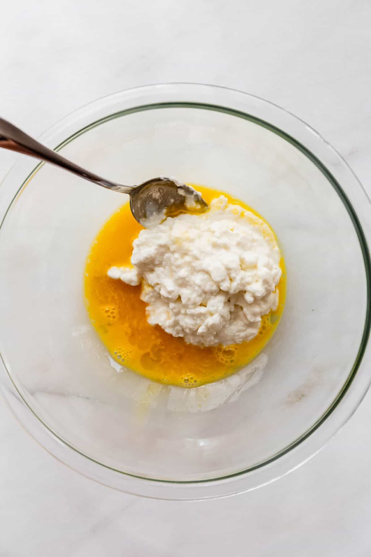 egg and cottage cheese in a mixing bowl.