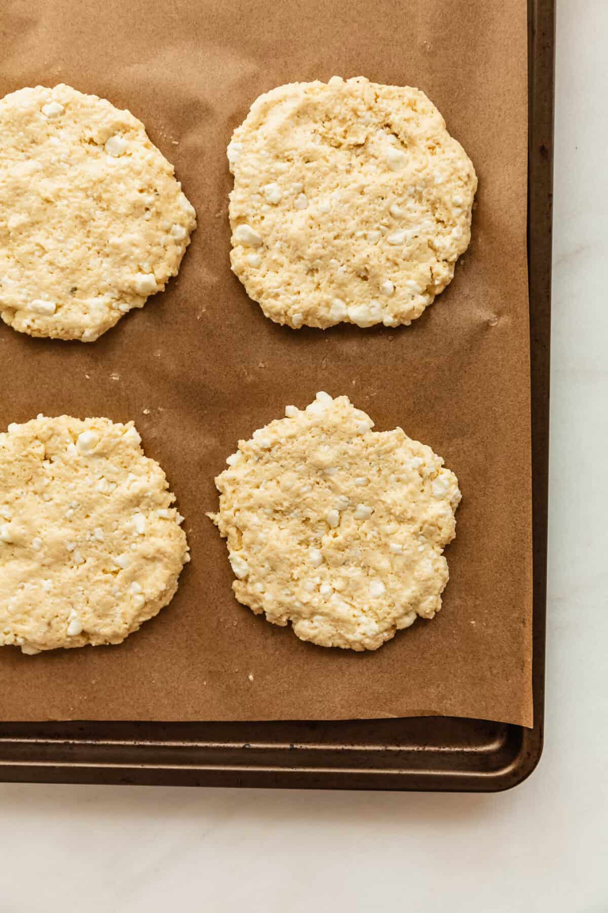 cottage cheese pizza dough buns on a baking sheet.