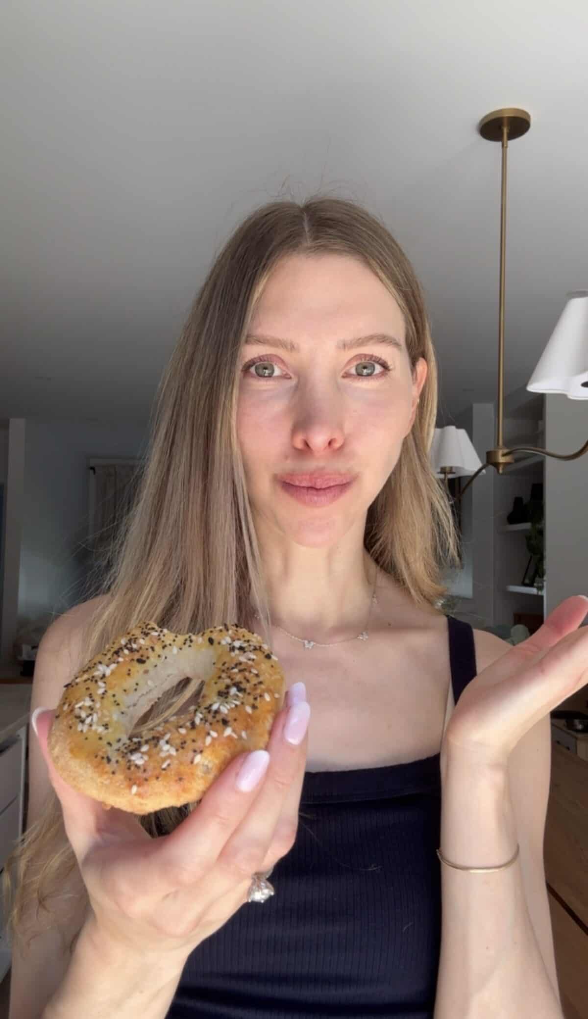 Girl eating a cottage cheese almond flour bagel.