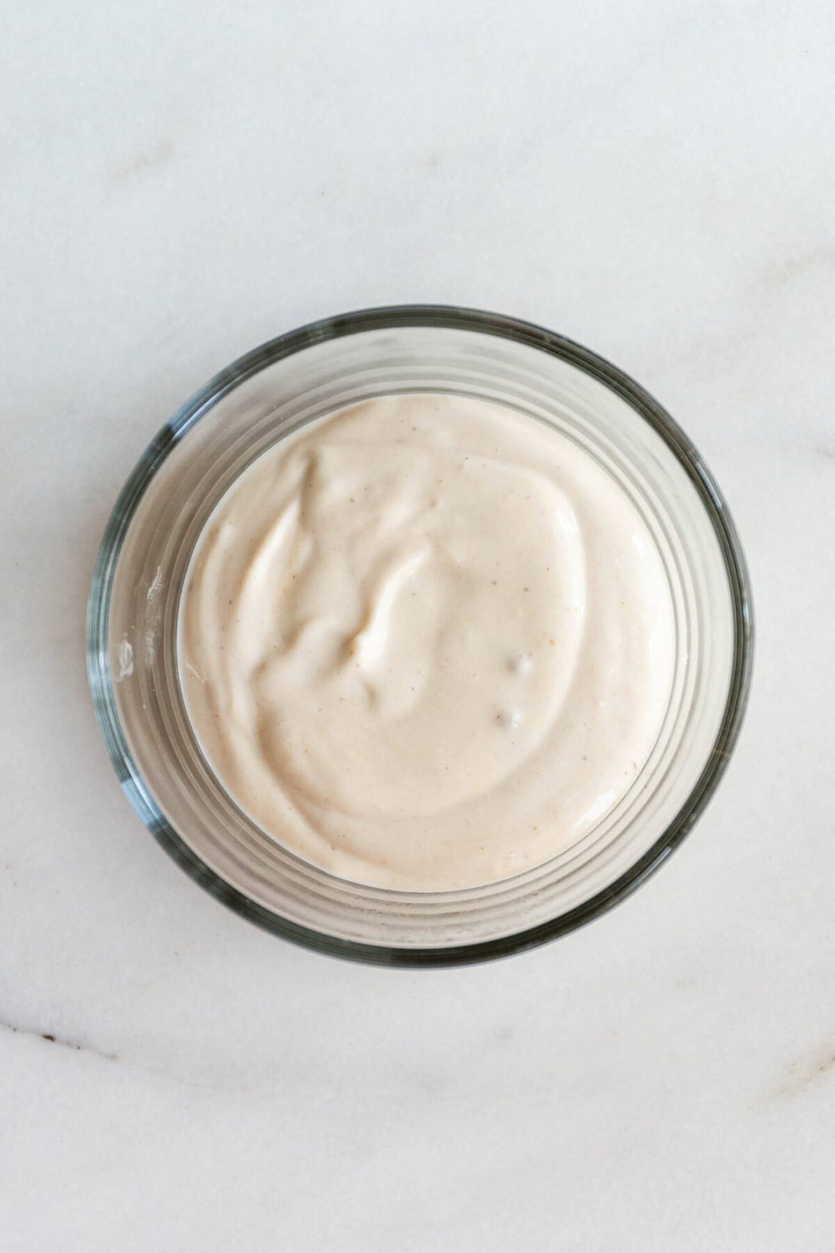 Greek yogurt in a clear bowl.