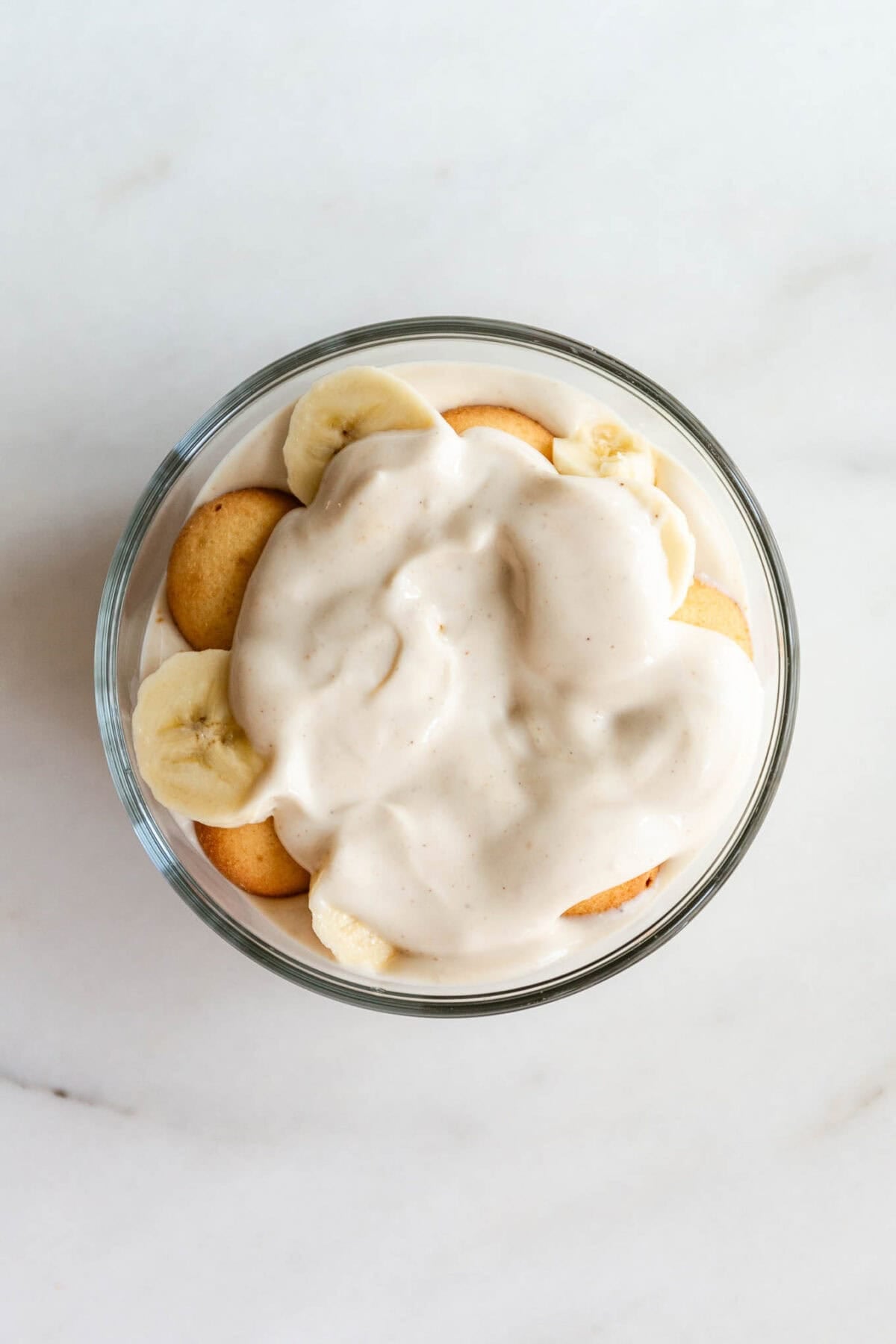 High protein banana pudding served in a glass container.