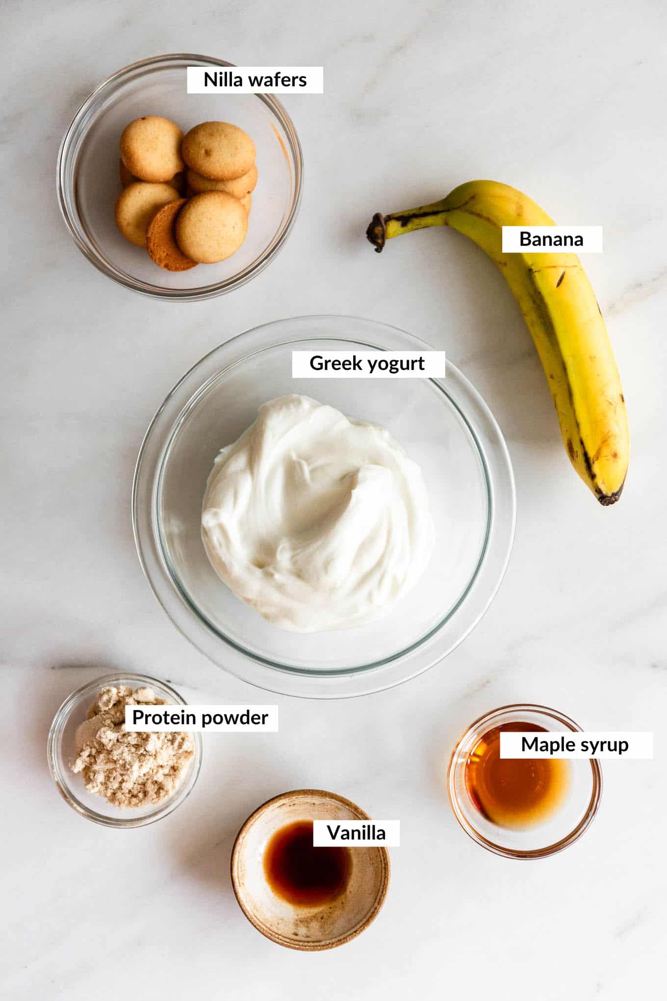 Ingredients for high protein banana pudding including Greek yogurt, banana, and vanilla pudding mix.