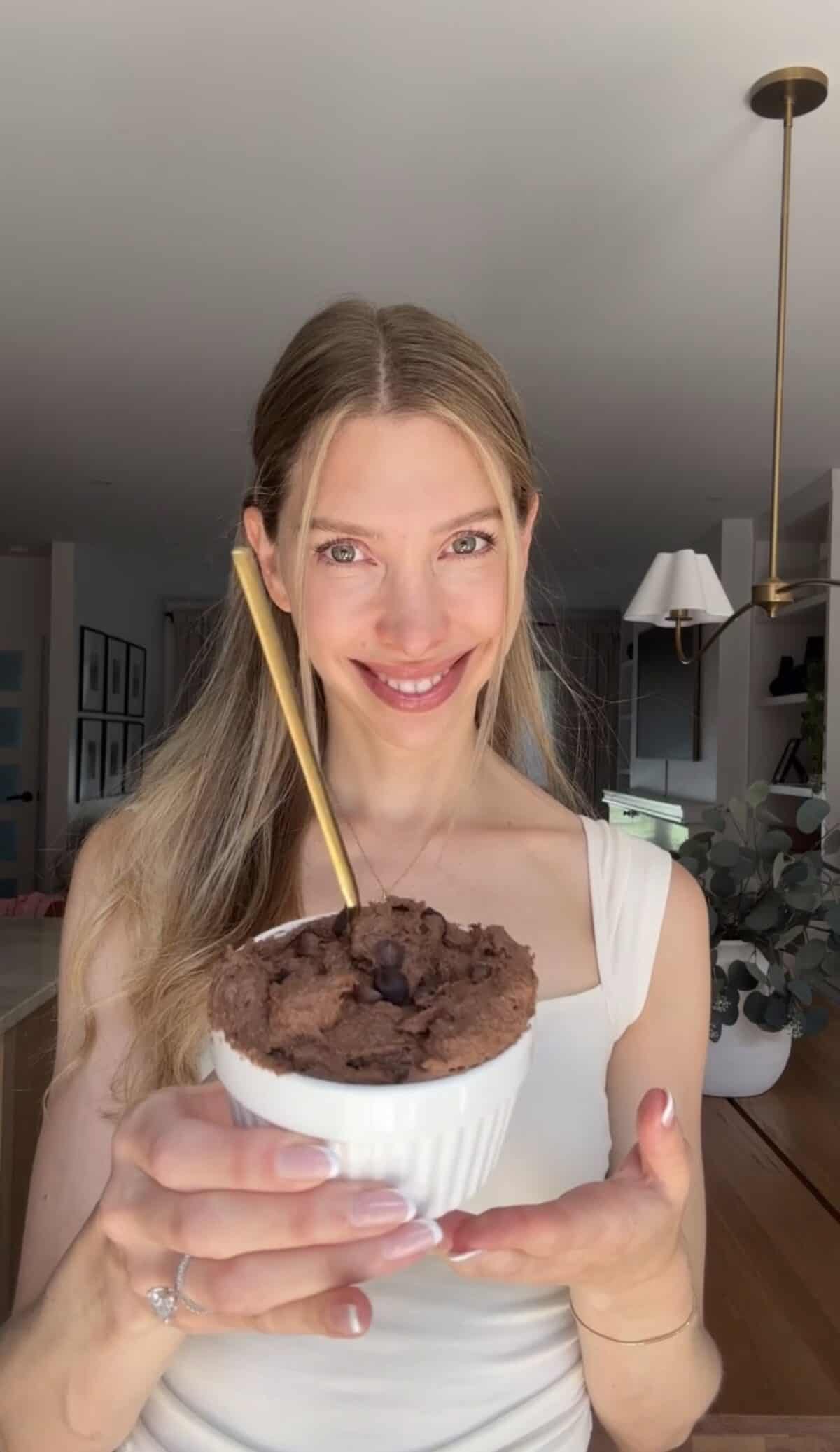 Jess from Choosing Chia holding cottage cheese brownie batter.