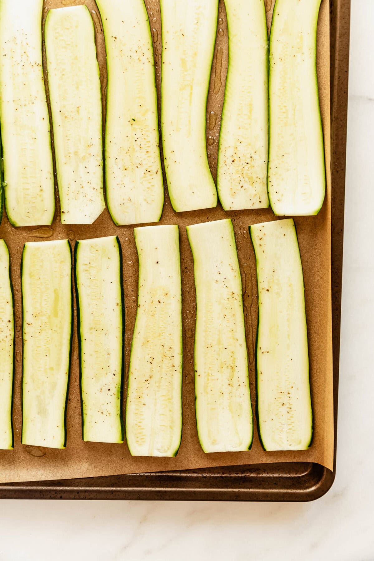 sliced zucchini on a baking sheet.