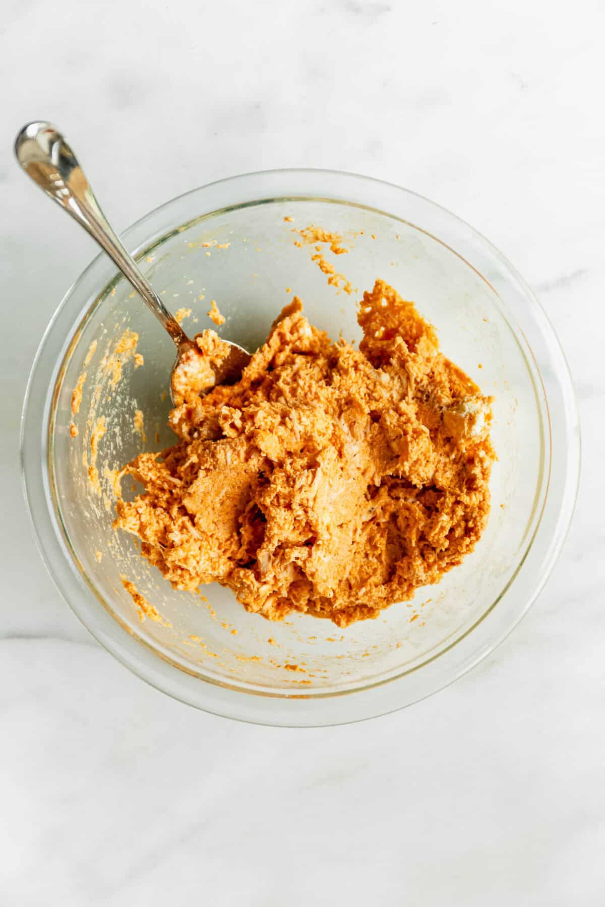 buffalo chicken ricotta filling in a clear mixing bowl.